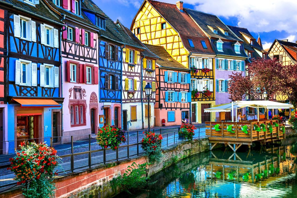 lefrancophile Colmar. timber framed coloured houses on canal bank